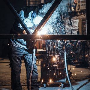 Welding work with metal construction at busy metal factory